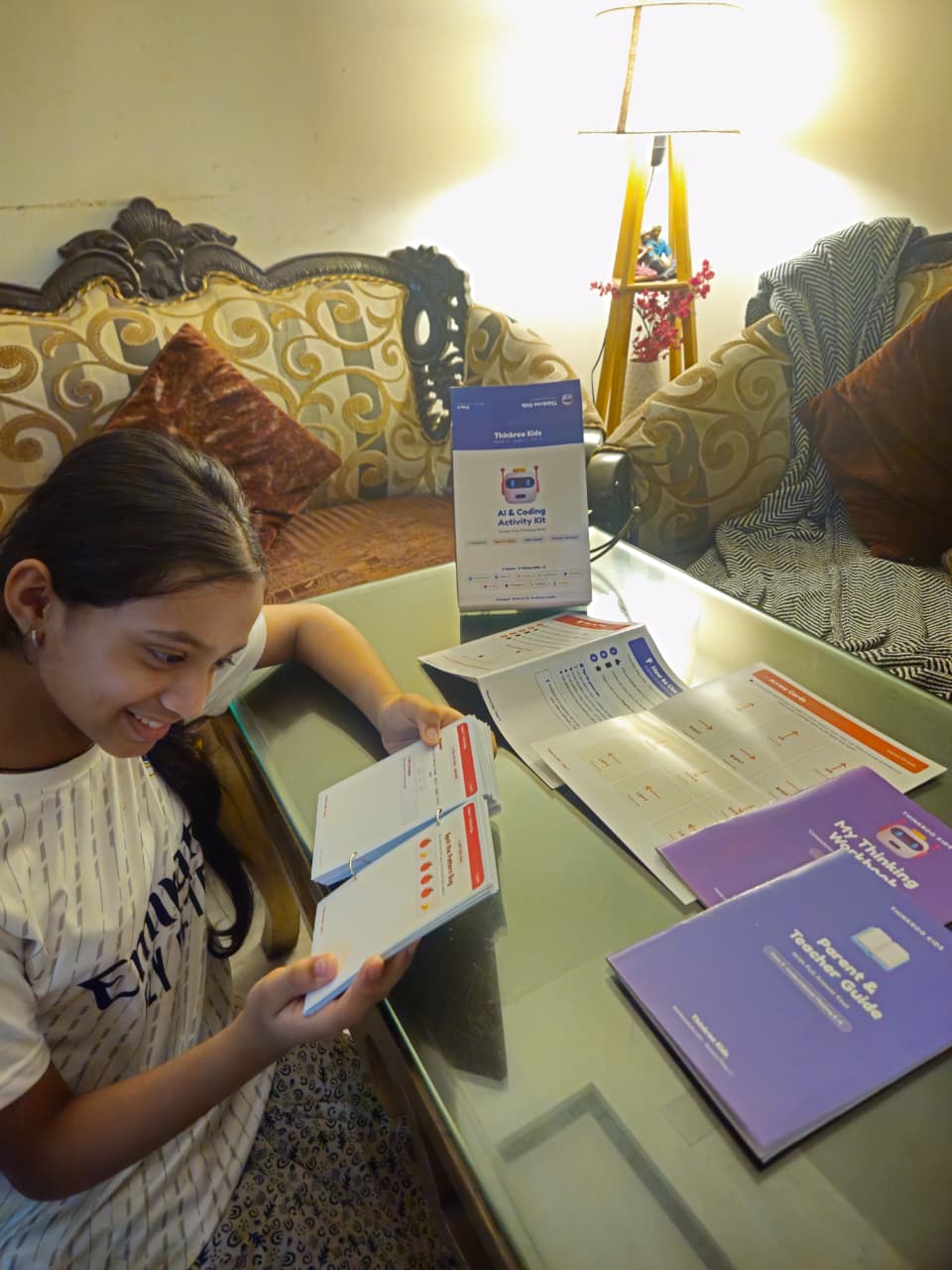 A child solving a Thinkroo activity card at a desk